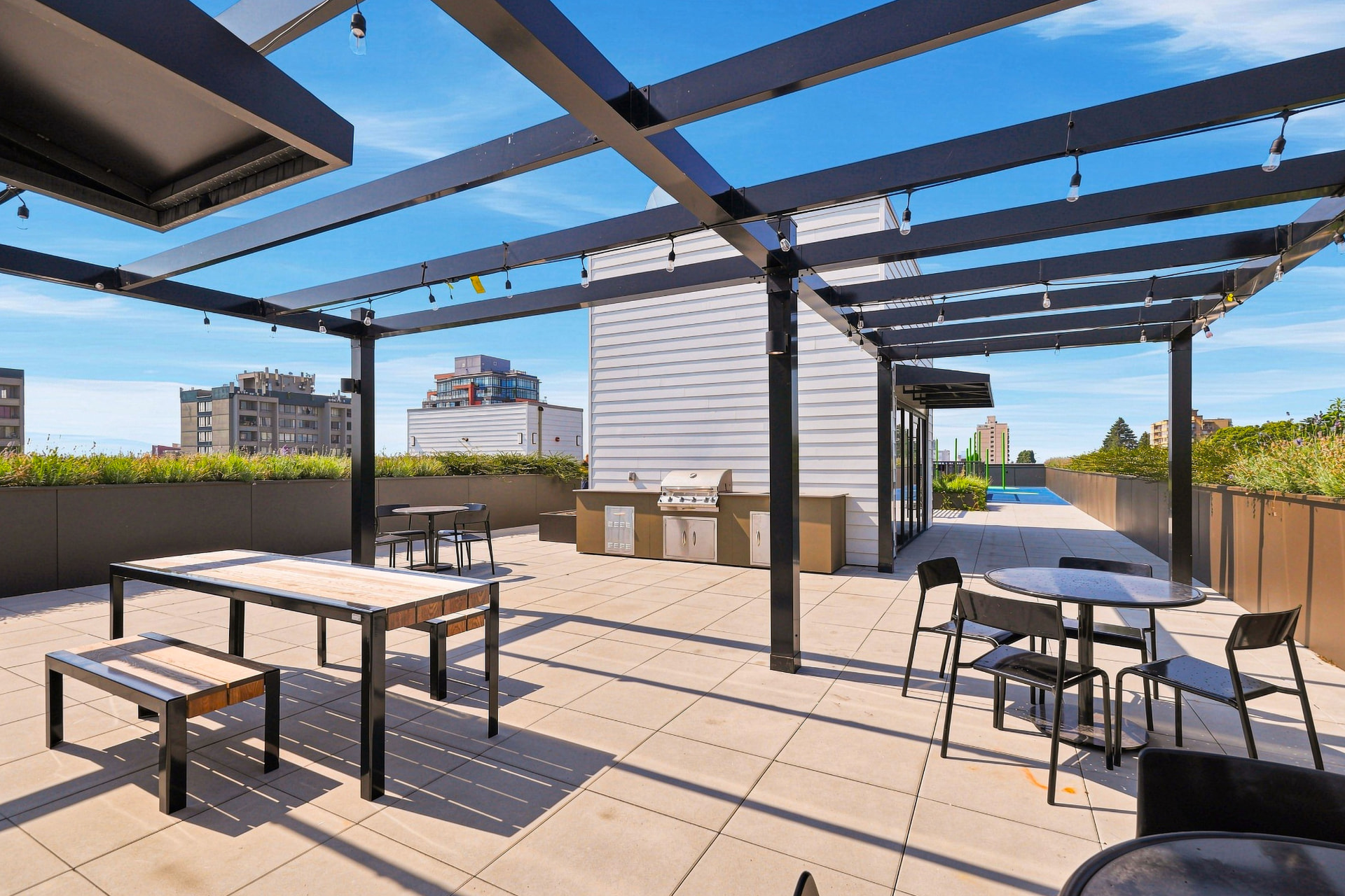 First & Royal rooftop BBQ and dining terrace with pergola seating, New Westminster